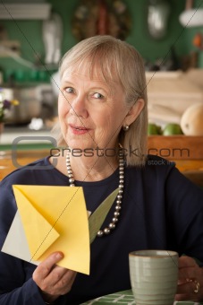Senior woman with greeting card