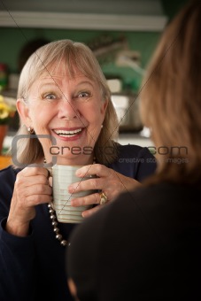 Senior woman in kitchen with daughter or friend