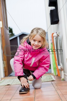 Little Girl tying her shoes