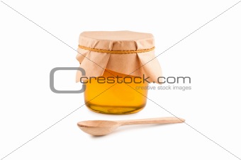 Honey in jar, spoon, isolated white background.