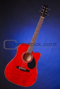 Acoustic Guitar Isolated on Blue