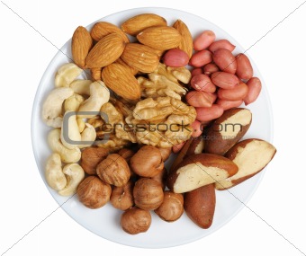 Set of nuts on a white plate, isolation