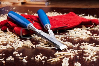 Chisels, red gloves and wood shavings 