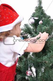 child decorating Christmas tree