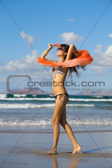 young  woman dancing with kerchief against the blue sky