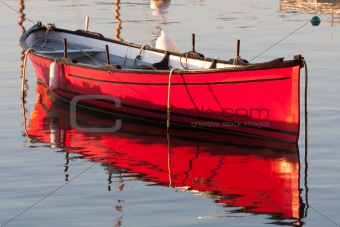 Morning light on a red boat 