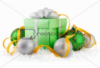 gift in snow with bow and  green balls