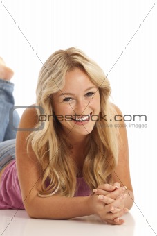 Portrait of casual young girl with jeans laying on floor