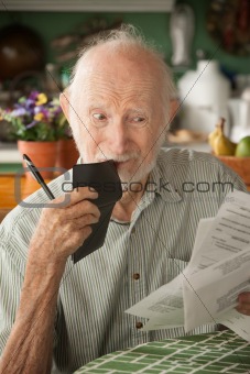 Senior man with many bills