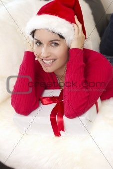 A beautiful sexy girl is smiling holds a gift box