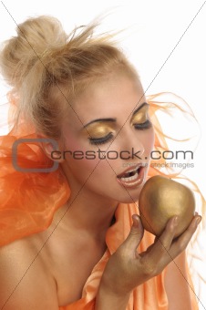 Beautiful woman in gold with apple