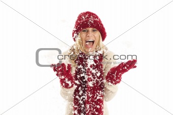 Young woman with red hat and scarf throwing snow