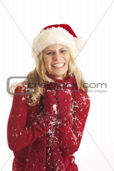 Young woman with Santa hat holding snow