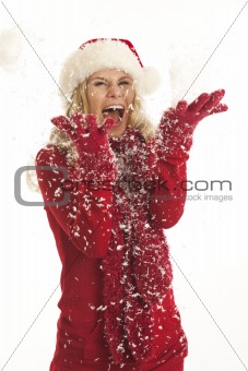 Young woman with Santa hat throwing snow
