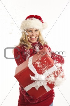 Young woman with Santa hat holding present