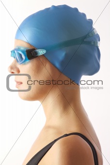 Close up portrait of young woman with swim cap and  swimming goggles