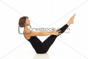 Young woman doing yoga Navasana Boat Pose
