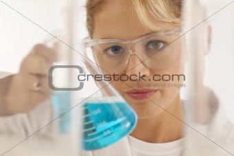Close-up of scientist holding beaker