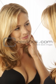 Woman looking at reflection in mirror