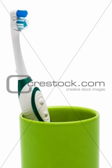 Toothbrush in a green glass