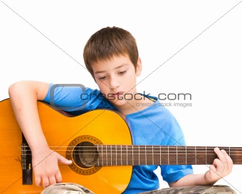 caucasian boy learning to play acoustic guitar; isolated on white background; horizontal crop