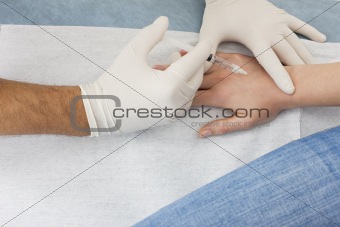 woman receiving an injection from a doctor