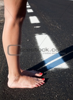 Barefoot woman in a road