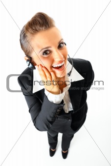 Full length portrait of  pleased telephone operator with headset
