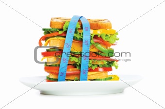 Concept of healthy food with tape measure and sandwich on white