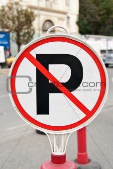 A no parking sign next to a road