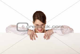 Young happy woman holds blank board and looks into camera