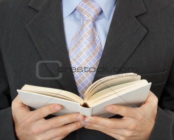Businessman reading statute book