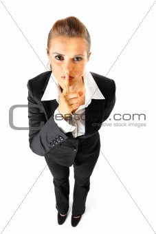  Full length portrait of modern business woman with finger at mouth. shh gesture
