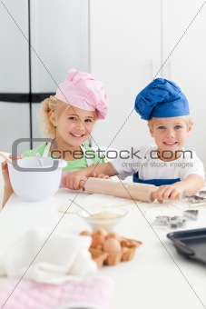 Cute sibling baking cookies together in the kicthen