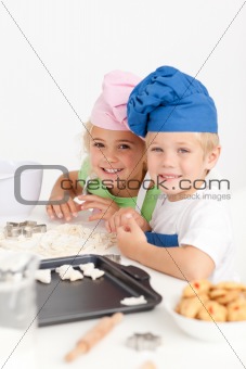 Two little chefs preparing cookies in the kitchen 