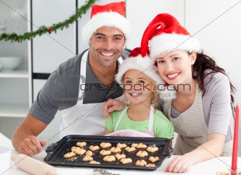 Happy woman with husband and daughter ith their biscuits ready 