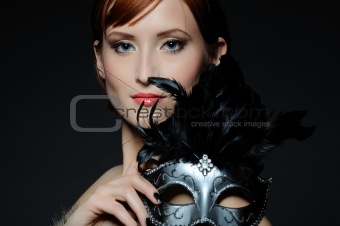 Beautiful woman with perfect party make-up in carnival mask