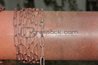 Rusty chain wrapped around the metal cylinder