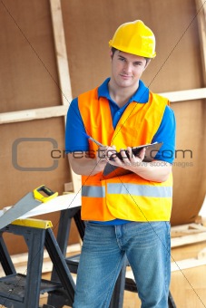 Confident male worker holding a clipboard