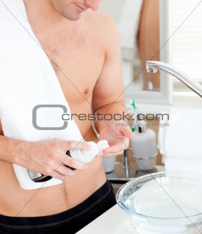 Close-up of a good-looking man preparing to shave in the bathroo