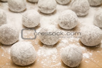 tray of  chocolate dough balls with icing sugar dusting (making cookies) abouit to go into oven