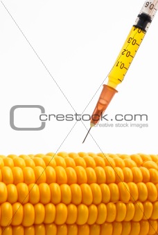 Syringe injecting into corn