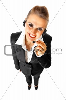 Full length portrait of  smiling telephone operator with headset
