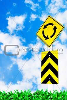 traffic circle road sign on beautiful sky
