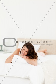 Pensive woman lying on his bed during a morning