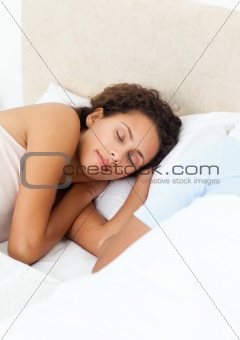 Pretty woman sleeping peacefully on her bed in the morning