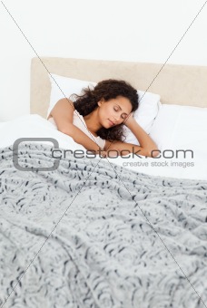 Beautiful woman sleeping peacefully on her bed in the morning