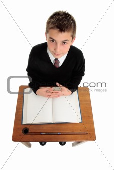 School boy sitting at school desk