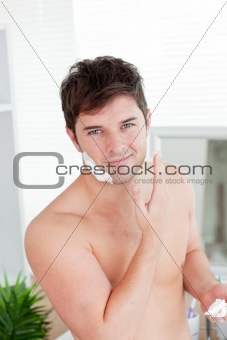 Cute caucasian man ready to shave in the bathroom