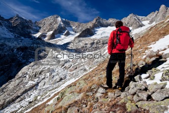 Hiker observing a high mountain panorama